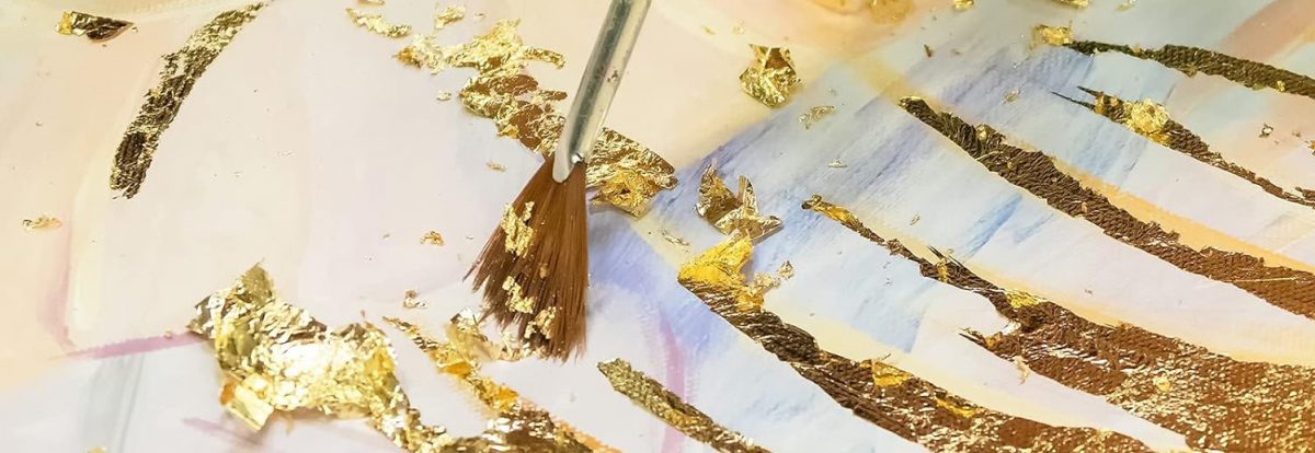 how to use gold leaf. Gold leaf being applied with a brush.