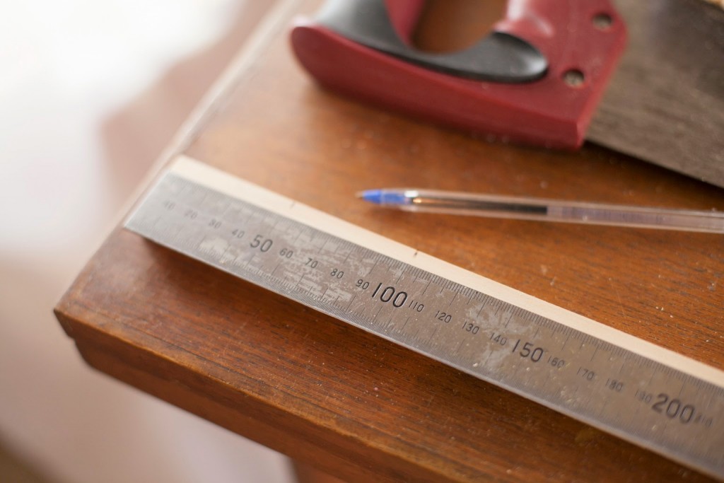 Measuring wood to make memory game.