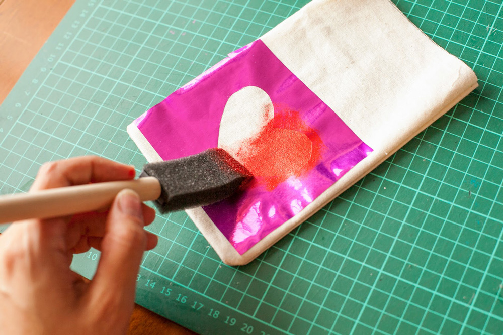 Painting heart with a stencil.